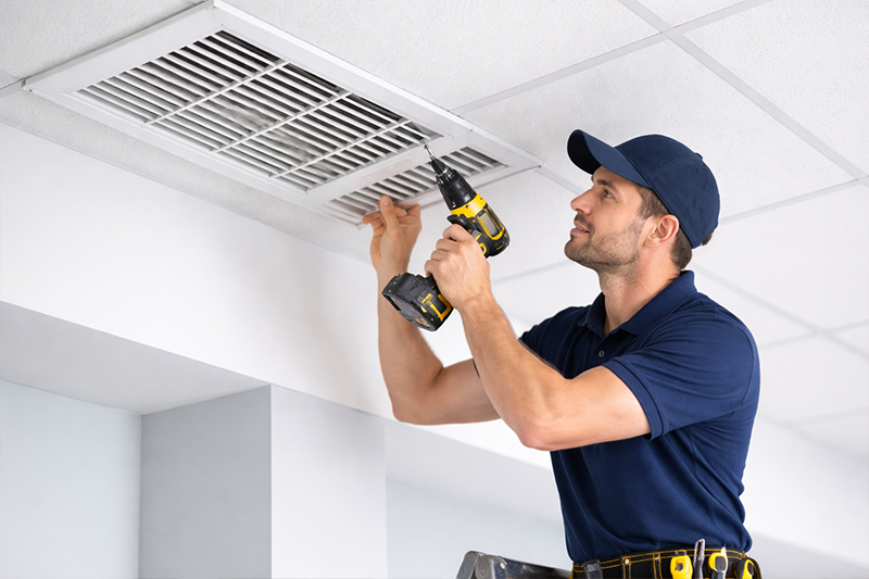 Air vent installation technician fixing ceiling HVAC vent